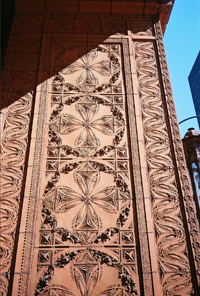 Up-close of exterior facade of terra cotta office building