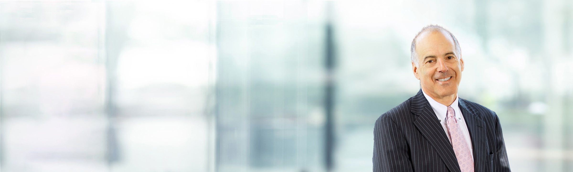 Kenneth Friedman on light blue and white bokeh banner